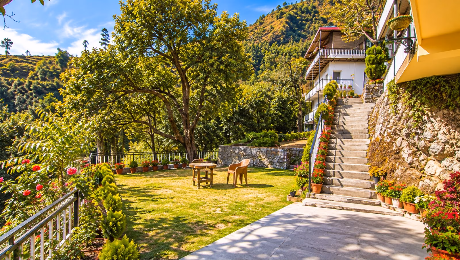 The garden lawn at The Sky Hotels with the hillside behind