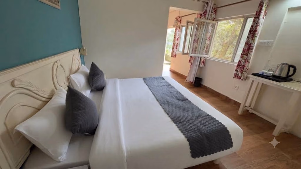 Bed and furnishings in Deluxe room 303